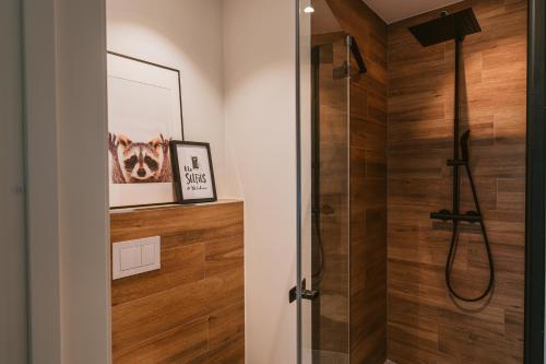 a bathroom with a shower with wood paneling at Frafjord Apartments Thor in Dirdal