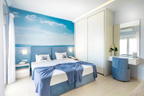 a blue and white bedroom with a bed and a sink at Villa Ariadne in Achlia