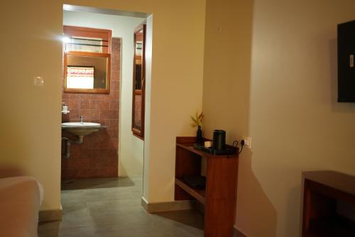 a bathroom with a sink and a mirror at Deva Maani Coorg Nature View in Madikeri