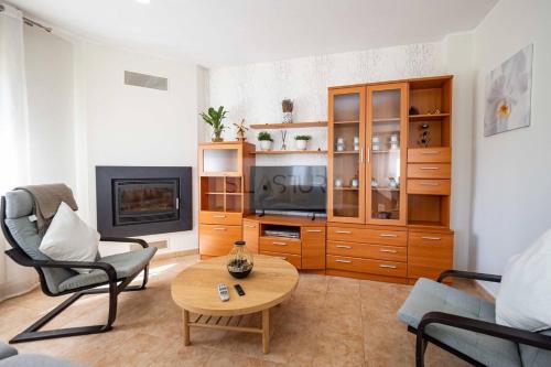 a living room with a tv and a coffee table at Martinica By Silastur in Ferrera