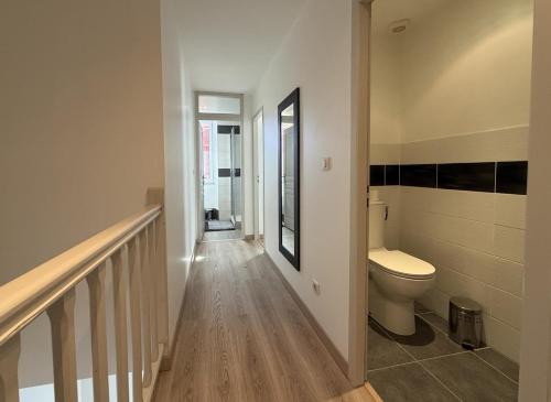 a hallway with a toilet and a staircase in a house at Anetania in Saint-Palais