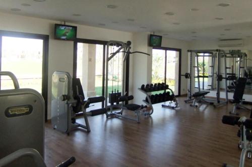 a gym with several treadmills and machines in a room at Jaz Little Venice Golf Resort in Ain Sokhna