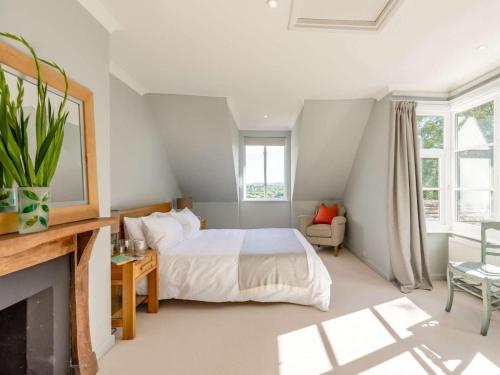 a bedroom with a bed and a fireplace at 4 Bed in Pulborough oc-89346 in Fittleworth
