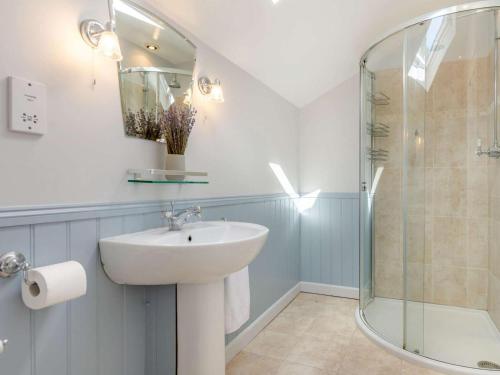a bathroom with a sink and a glass shower at 4 Bed in Pulborough oc-89346 in Fittleworth