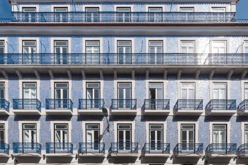 a facade of an apartment building with blue balconies at Ando Living - Abrantes 50 House in Lisbon