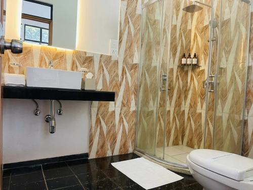 a bathroom with a shower and a toilet at Aqua Hotel Yala in Yala