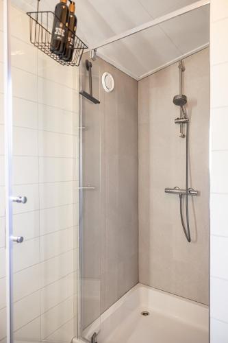 a bathroom with a shower with a glass door at Leva - Logeren in Drenthe in Doldersum