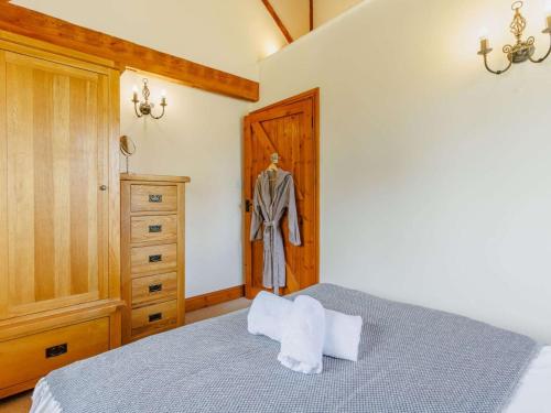 a bedroom with a bed and a wooden door at 3 Bed in Launceston oc-88858 in Saint Giles on the Heath