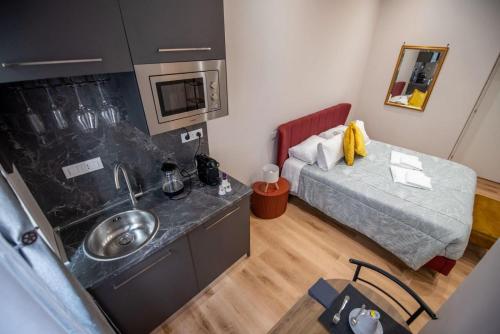 a small room with a sink and a bed at Assarotti Luxury Suite in Genoa