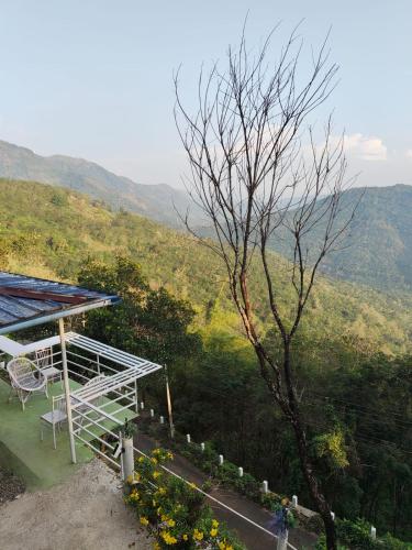 a building with a view of a mountain at Misty Moutain view in Pīrmed