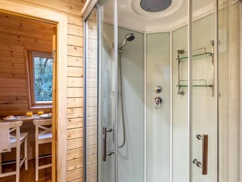 a shower stall in a bathroom with a table at 1 Bed in Padstow oc-77748 in Padstow