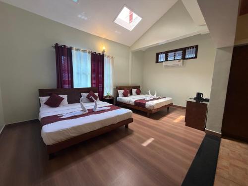 a hotel room with two beds and a window at Deva Maani Coorg Nature View in Madikeri