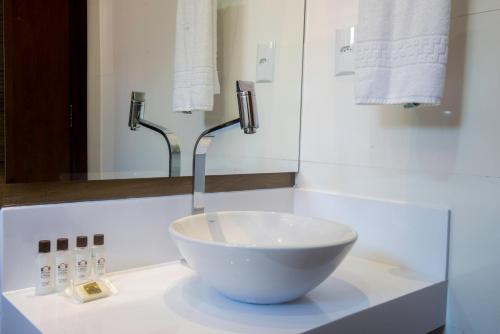 a bathroom with a bowl sink on a counter at Cristal Pousada in Morro de São Paulo