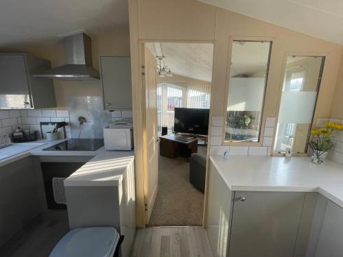 a kitchen with a sink and a toilet in it at Large family holiday home in Gunton