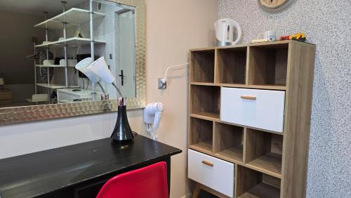 a room with a desk with a lamp and a mirror at Zacisze in Sokółka