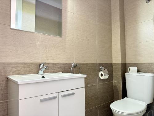 a bathroom with a white sink and a toilet at Agi Josep Sabater in Roses