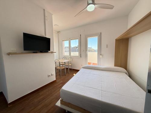 a bedroom with a bed and a flat screen tv at Agi Josep Sabater in Roses