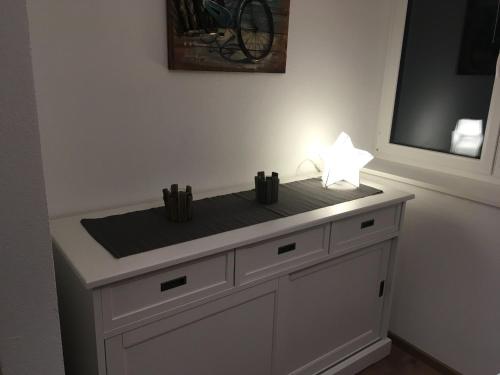 a white counter with a lamp on top of it at Seeterrasse in Allensbach