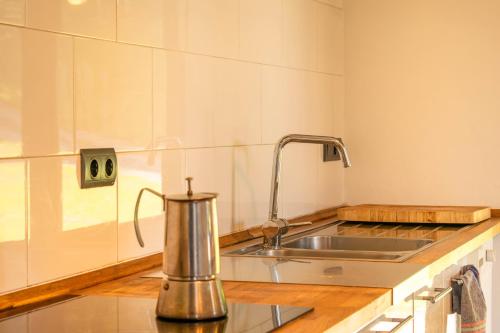 a kitchen with a metal tea kettle on a counter at Espectacular casa rural en el corazón del Baztán in Ziga