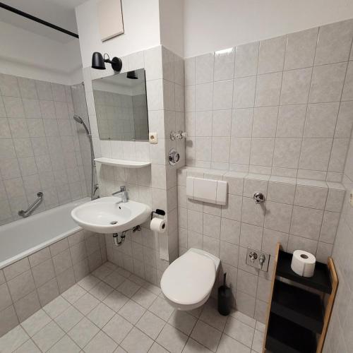 a bathroom with a toilet and a sink at Moderne 2 Zimmer Appartement in Straubing