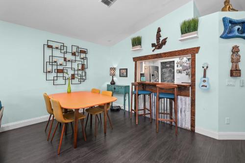 a kitchen and dining room with a table and chairs at PrivateTropical Oasis in Jax Beach in Jacksonville Beach