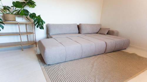 a couch sitting in a corner of a room at Spacious Nordic Cph Apt Garden I 5 Min to Metro in Copenhagen