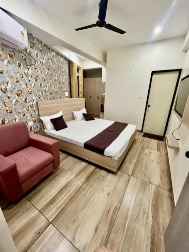 a bedroom with a bed and a couch at Deni Hotel in Patna