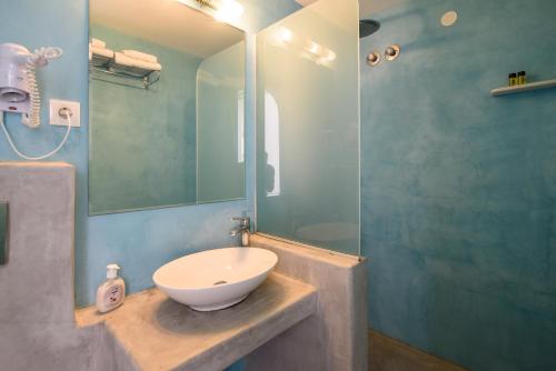 a bathroom with a sink and a shower at RK Beach Hotel in Kamari