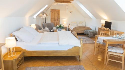 a bedroom with a bed and a living room at Apartmány U Petry in Luhačovice