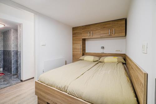 a bedroom with a large bed and a shower at Apartment Kamrca na Kopah in Šmartno pri Slovenj Gradcu