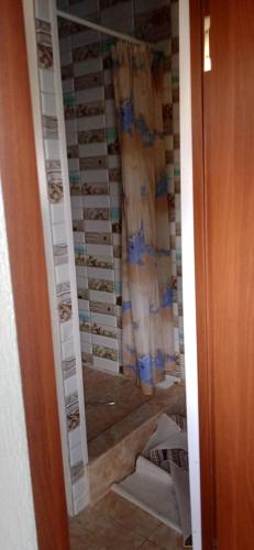 a shower in a bathroom with a glass door at Лазурит in Tamga