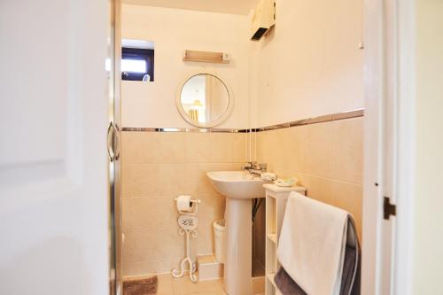 a small bathroom with a sink and a mirror at Farm stay close to Shakespeare's Stratford-upon-Avon in Stratford-upon-Avon