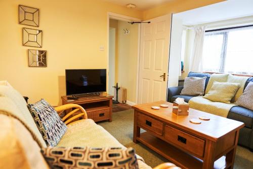 a living room with a couch and a table at Farm stay close to Shakespeare's Stratford-upon-Avon in Stratford-upon-Avon