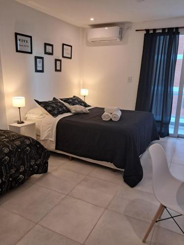 a bedroom with a bed with two towels on it at Monoambiente zona UNNE in Resistencia