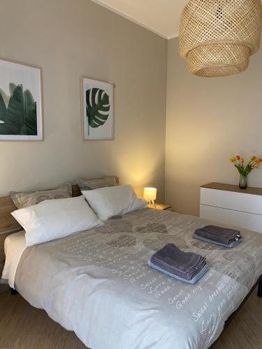 a bedroom with a bed with two towels on it at A Casa di Katia in Collegno