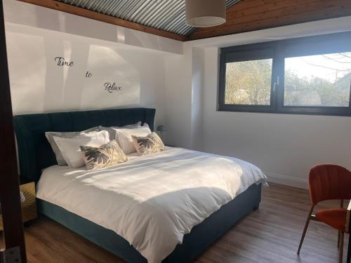 a bedroom with a bed with white sheets and a window at Lily's Place in Wexford