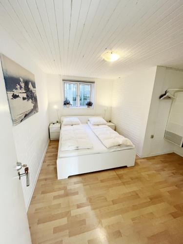 a bedroom with two beds in a white room at Central Large Double Room with free parking in Aalborg