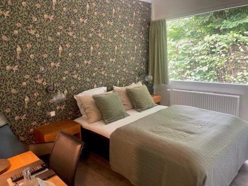 a hotel room with a bed and a window at Rørvig Centret in Rørvig