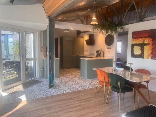a kitchen and dining room with a table and chairs at Lily's Place in Wexford