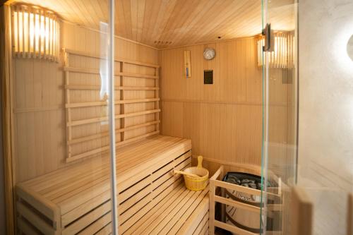 a sauna with wood paneling and a glass wall at Elysium suites & Spa in Barletta