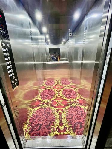 an elevator with a painting of a floor with roses at Deni Hotel in Patna