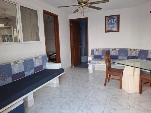 a living room with a couch and a table and chairs at Casa Rosa in Tequesquitengo