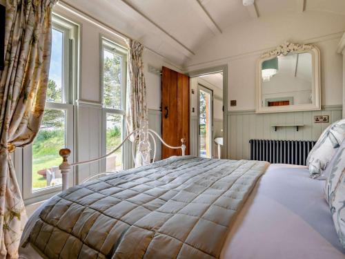 a bedroom with a large bed with a large window at 1 Bed in Camelford oc-95316 in Camelford