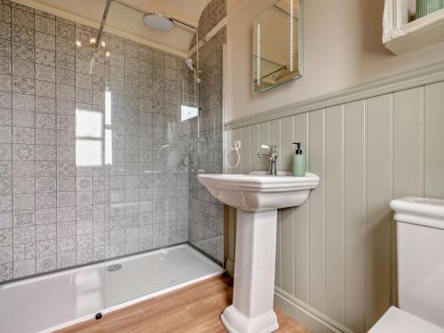 a bathroom with a sink and a shower and a toilet at 1 Bed in Camelford oc-95316 in Camelford