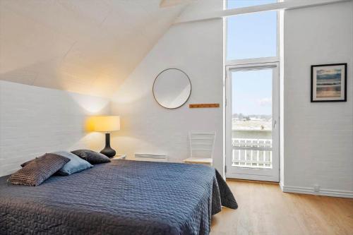a bedroom with a bed and a large window at 1356-Thisted-Nordsovej-106 in Thisted