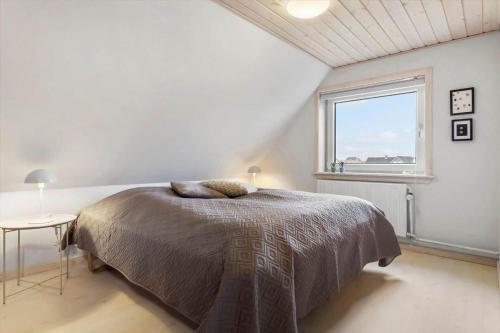 a bedroom with a bed and a large window at 1375-Thisted-Nordsovej-15 in Nørre Vorupør