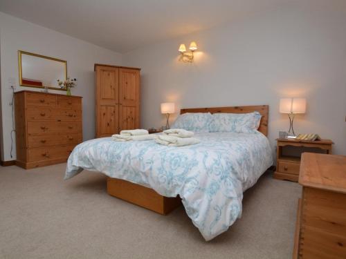 a bedroom with a bed with two towels on it at 2 Bed in Bridport oc-dc162 in Chideock