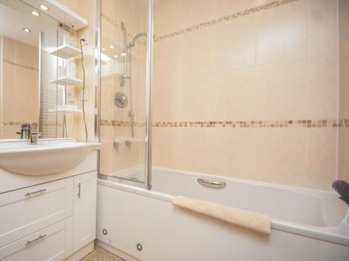 a bathroom with a tub and a sink and a shower at 2 Bed in Bridport oc-dc162 in Chideock