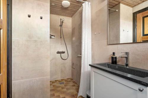 a bathroom with a shower and a sink at 3392-Hvide-Sande-Fyrmarken-10 in Hvide Sande