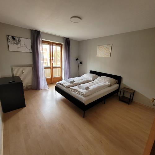 a bedroom with a large bed in the middle of a room at Moderne 2 Zimmer Appartement in Straubing